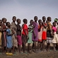 Young girls queue up to be registered for school at an emergency food distribution site. Kate Holt.