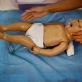 A trainee nurse, who attends the nursing college that receives technical support from MCHIP, demonstrates on a baby doll. Kate Holt.