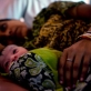 A mother holds her newborn baby in Kolibera health centre near to Ranchi, India Friday, May 30, 2014. Kate Holt.
